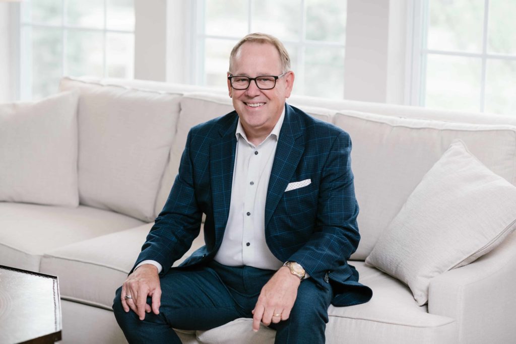 Speaker and best selling author of UnCommon Leadership®, Ed Chaffin, sitting on couch