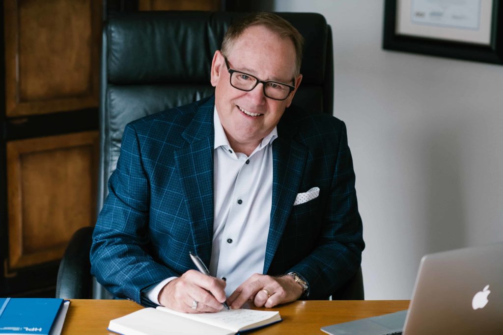 Speaker and best selling author of UnCommon Leadership®, Ed Chaffin, sitting at desk